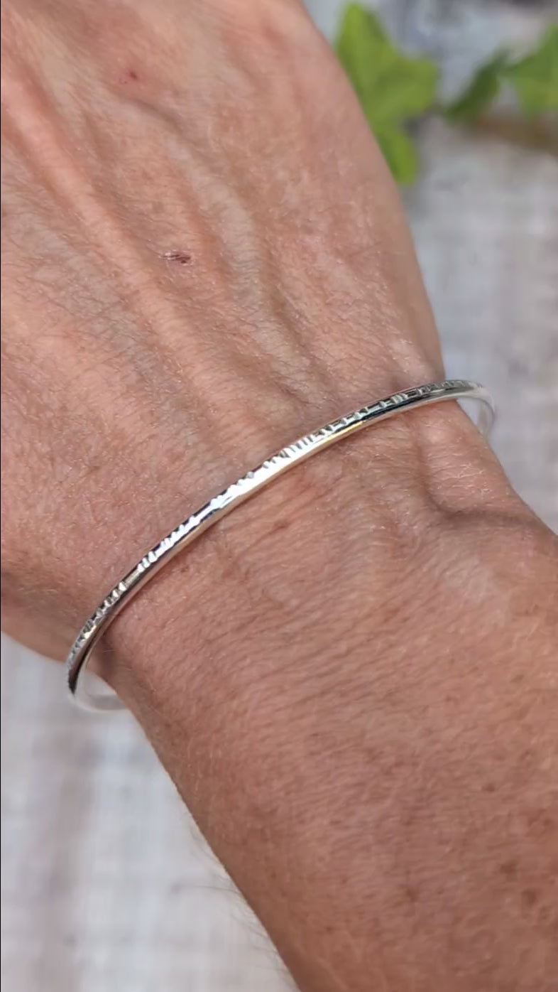 Video of Silver Textured Oval Cuff Bangle worn on the wrist, showing the handmade hammered edge detail and smooth Sterling Silver finish.