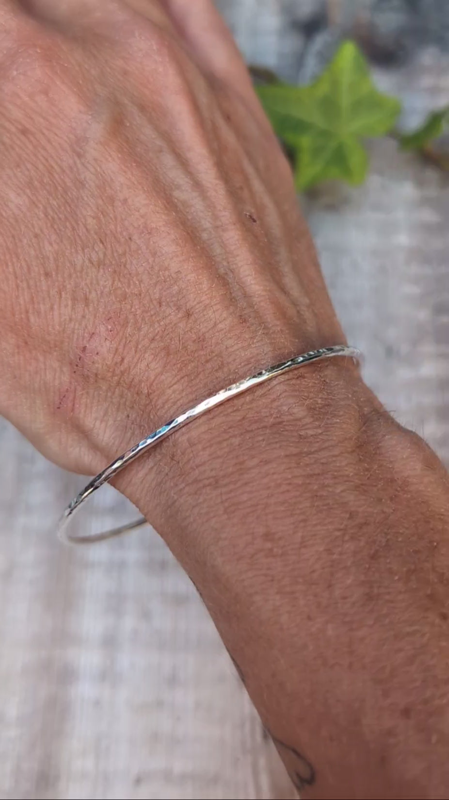 Video of Silver 2mm Hammered Round Bangle worn on the wrist, showing the simple slim design and hand hammered finish.