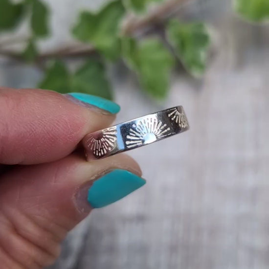 Video of Silver 5mm Sunrise Ring handmade from recycled Sterling Silver with a hand stamped sunrise pattern, shown held between fingers from a different angles. 