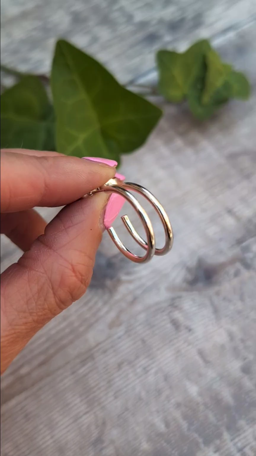 Close up of Silver smooth hoop earrings handmade from recycled Sterling Silver, highlighting the smooth polished finish and post fittings.
