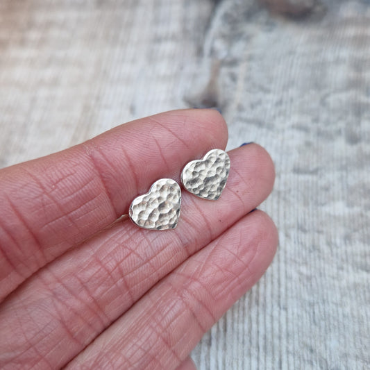 Each earring is a Sterling Silver heart shape with hammered texture mounted on a stud bar.